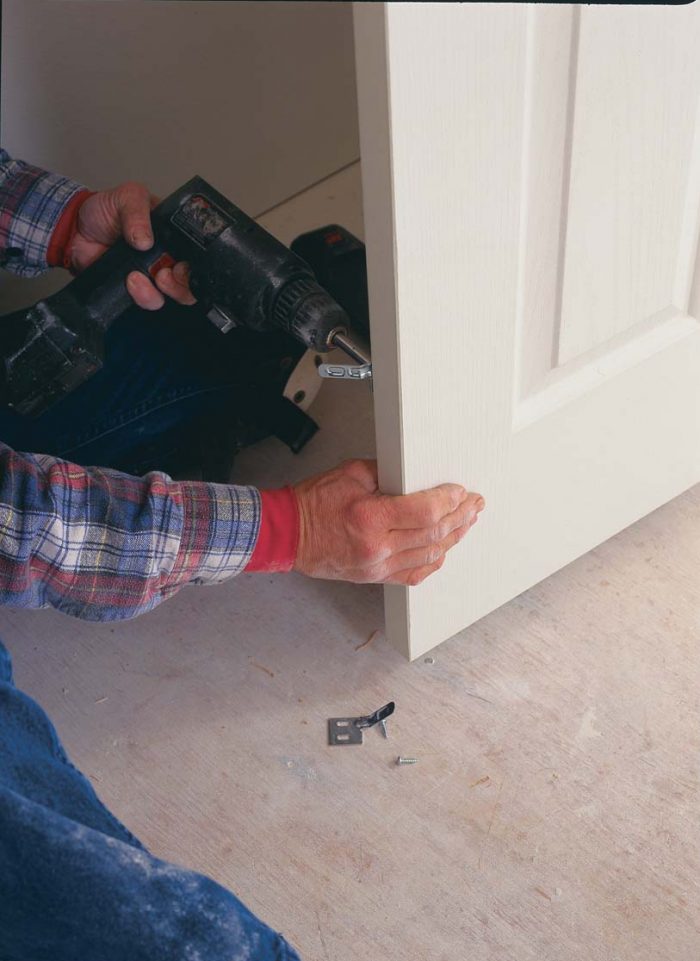 Aligners keep the guide doors flush with one another. Metal tabs called aligners are installed about 12 in. above the floor on the backside of the bifold doors.