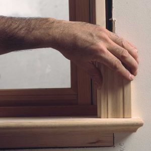 A gap between the casing leg and the stool sticks out like a sore thumb. A casing scrap is used to check if the stool is square to the jamb. The author trims the square windows first, then comes back to custom-cut the casing for the outof- square windows.