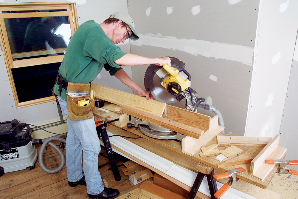 an auxiliary plywood fence with a stop applied to the front edge ensures that the molding is held at the correct angle in relation to the blade