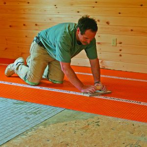 wooden float to bond mortar to tile a big floor