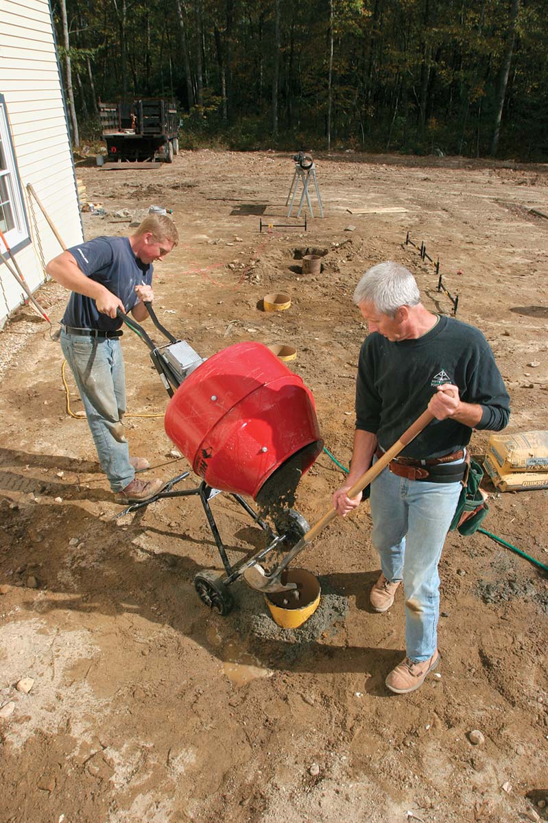 Filling tubes with concrete.