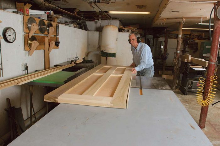 fter sanding both sides of the door flat with a belt sander (you can also pay a local millwork shop to run the doors through a wide belt sander), I trim the top and bottom of the door, then rip a 3° bevel on the strike-side stile.