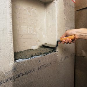 slope bottom of shower niche to shed water