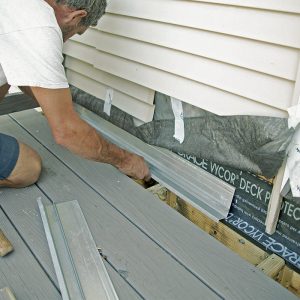 Layers of protection. After applying a strip of self-adhering membrane to the top of the ledger and onto the wall, install new flashing (everflashing.org) over the ledger.