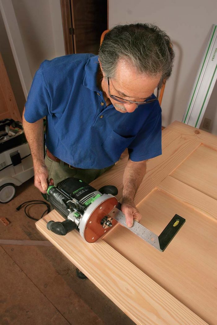 Cut the slot. An L-shaped guide mounted to the floor prevents the door from swinging and hitting the wall or the casing as it’s opened and closed.