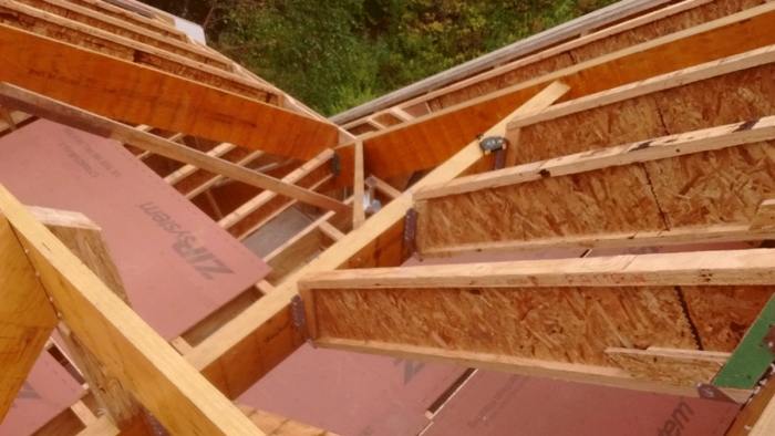 A view from the spot where the cross-gable ridge meets the plane of the main roof and down the center of the overlay valley area and the true valley that runs between the sub-ridge and the rafter beam that supports the sub-ridge.The valley jack layout has three jacks. I marked measurements on the plan. The measurements are all runs (horizontal measurements). They are not diagonal measurements.