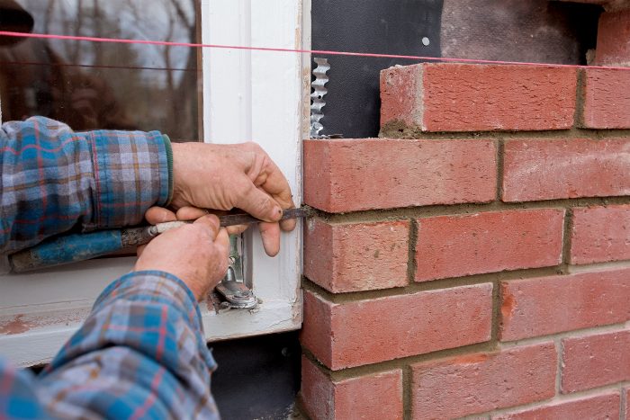 use a tuck to fit where the brick returns to the window