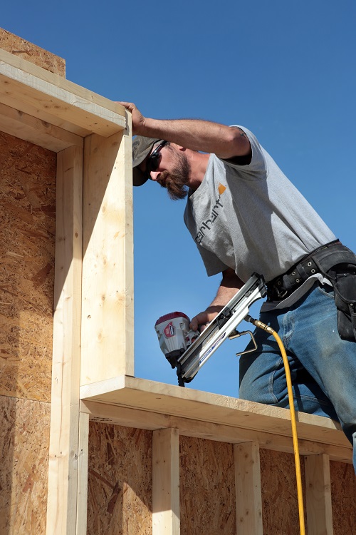 Mike nails off the top plate to accept the interior studs of the double-stud wall.