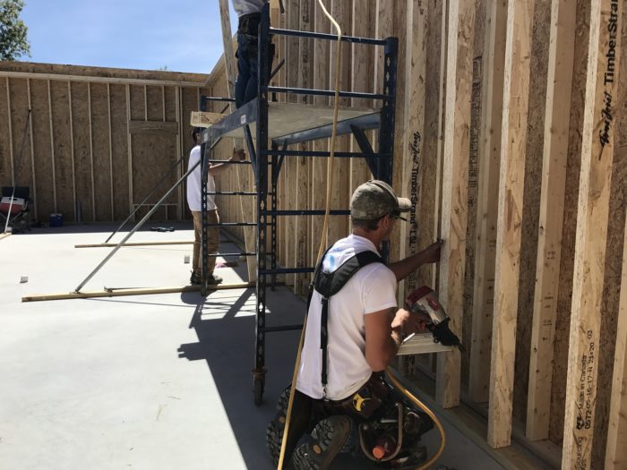 John nails the interior wall of TimberStrand 2x4s in place.