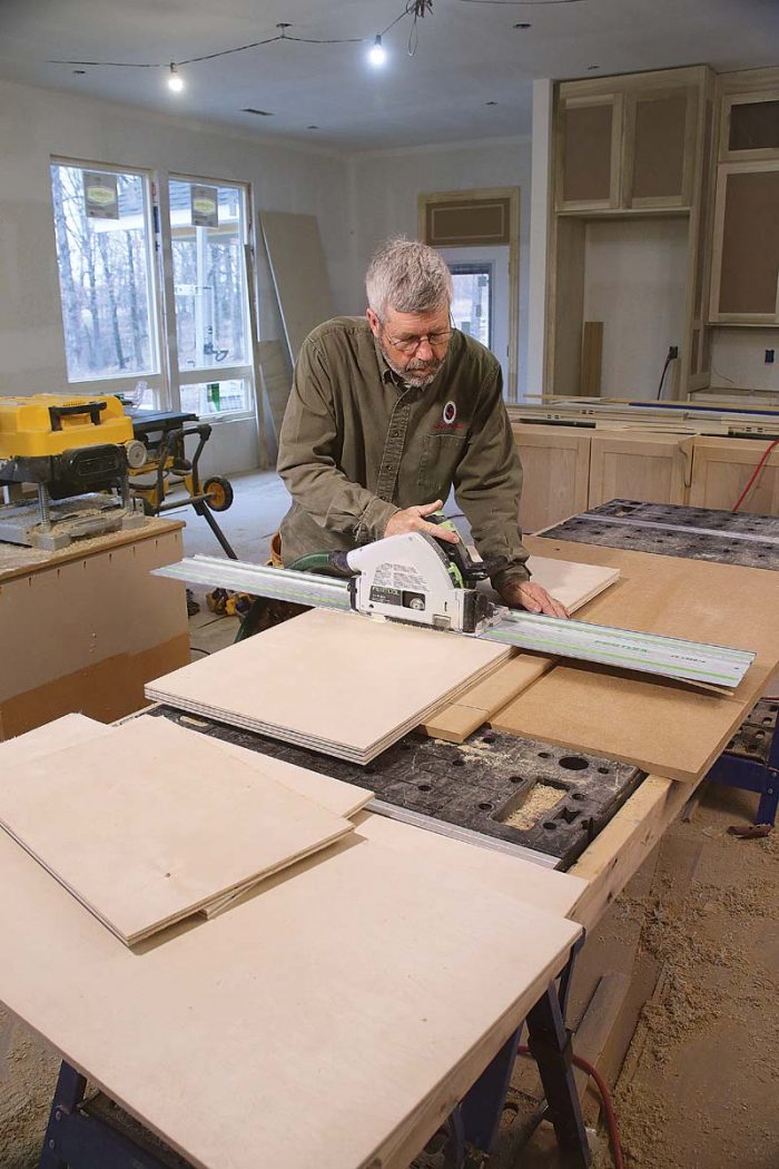 Perfect panels. A track saw makes quick work of breaking down the 1⁄2-in. plywood sheets used to make the door panels.