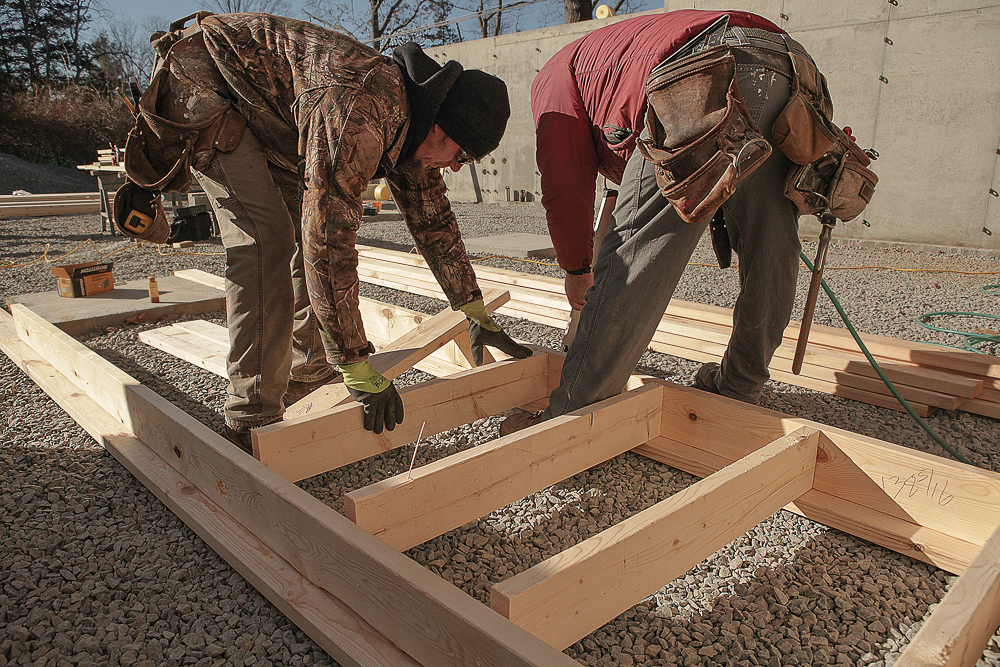 Bore 1-1⁄4-in. holes in the bottom plates of the cripple walls at anchor locations. Use the measurements from the story pole to determine your stud heights, deducting the thickness of the plates and mudsill from the height difference between the bottom of the new joists and the top of the concrete stem wall.