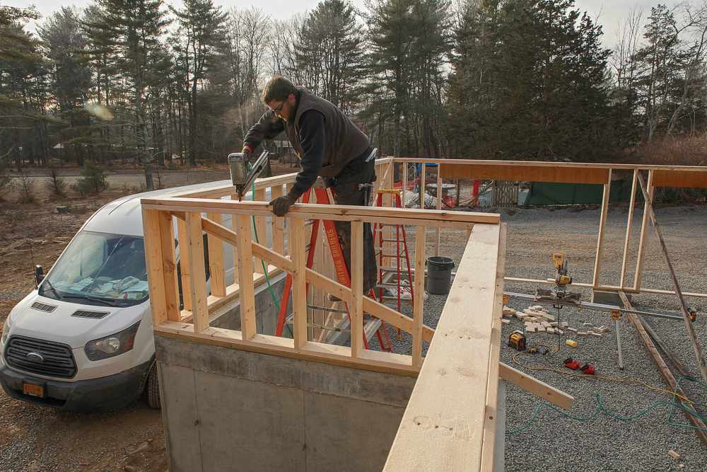  After everything is plumb, square, and straight, add the double top plates to lock all the wall sections together.