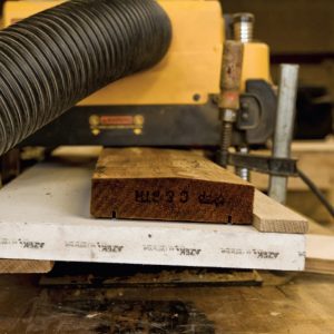 If you have a typical bench planer, a simple jig lets you make a custom railing cap out of standard 2x decking stock