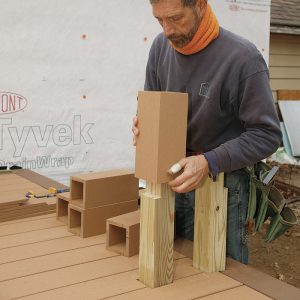 Place post sleeves before installing the bench frame