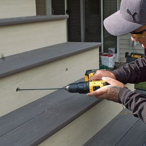 additional image of person holding a drill creating a hole 