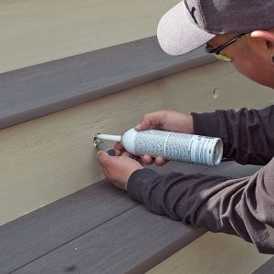 adding caulk to the drilled hole 