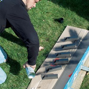 person spray painting the posts