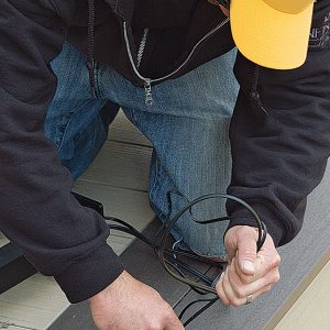 person running the cable through the posts 