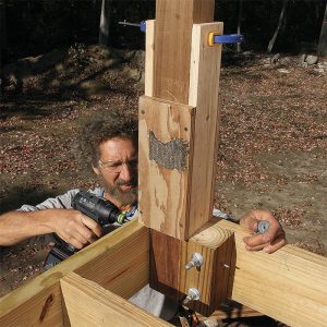 Add 4x4 blocking. Bolting into a block rather than just into the post places the bolts farther back along the joist. This reduces the chance that levering on the post will make the bolts split the end of the joist and cause a railing failure. Fasten 4x4 blocks 