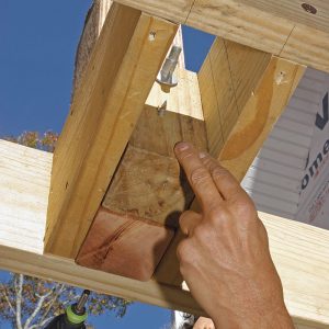 Back up the post with a 4x4 block. Cut to the height of the joists and positioned between the 2x blocks behind the post, the block is secured to the end joist and post with ThruLoks.