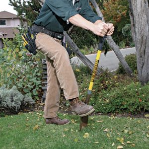 3 Use a square-nosed shovel to create a small slot to bury the cable.