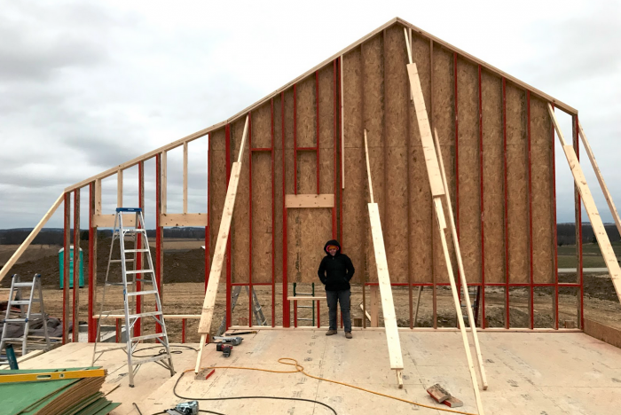 Sara in front of gable end wall