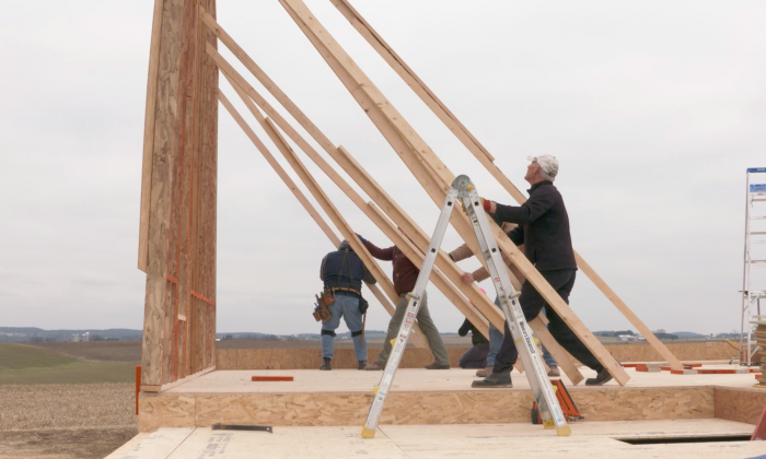 Team raising gable wall with 2x4s