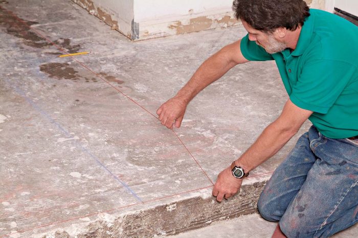 A chalkline snapped down the center of the hallway marks the center of the tile pattern in the entry area.