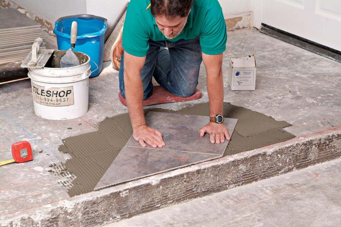 Subsequent tiles are set aligned to the first tile, with spacers between them to maintain even grout joints.