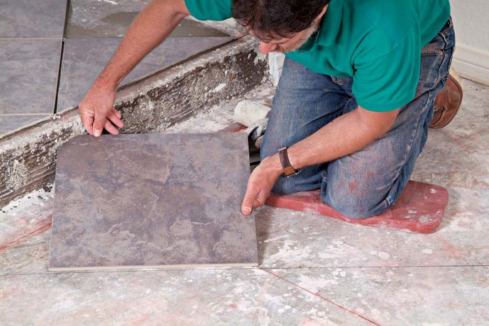 To maintain an even pattern across the stair step, the first tile on the lower level must be trimmed.