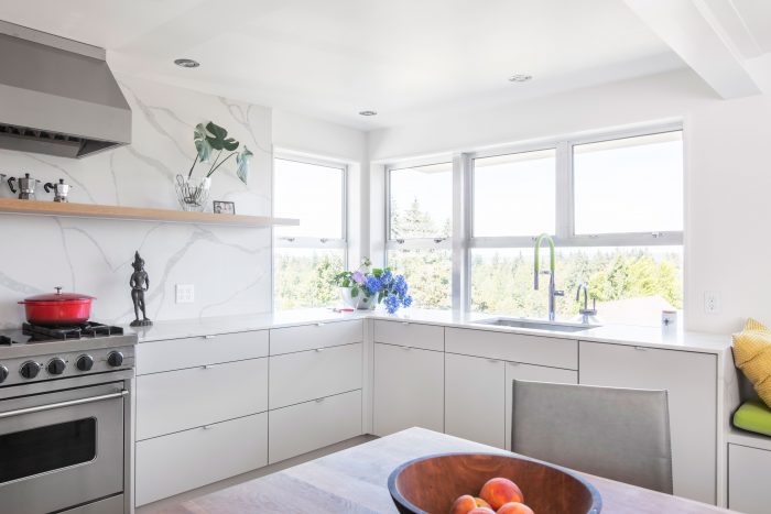 A bright kitchen with many windows in a corner