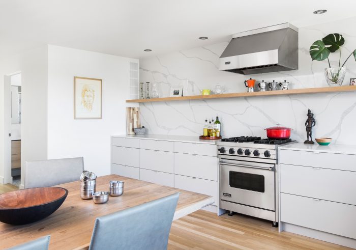 A kitchen with a dining room table and an oven