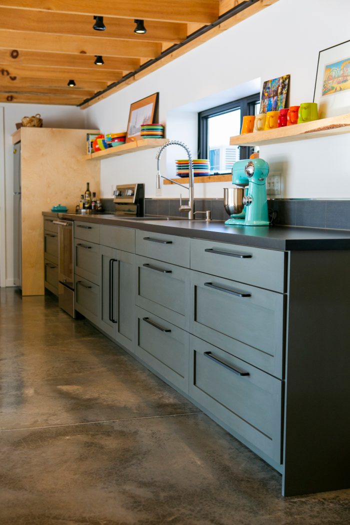 Kitchen with cabinets, sink, and floating shelves