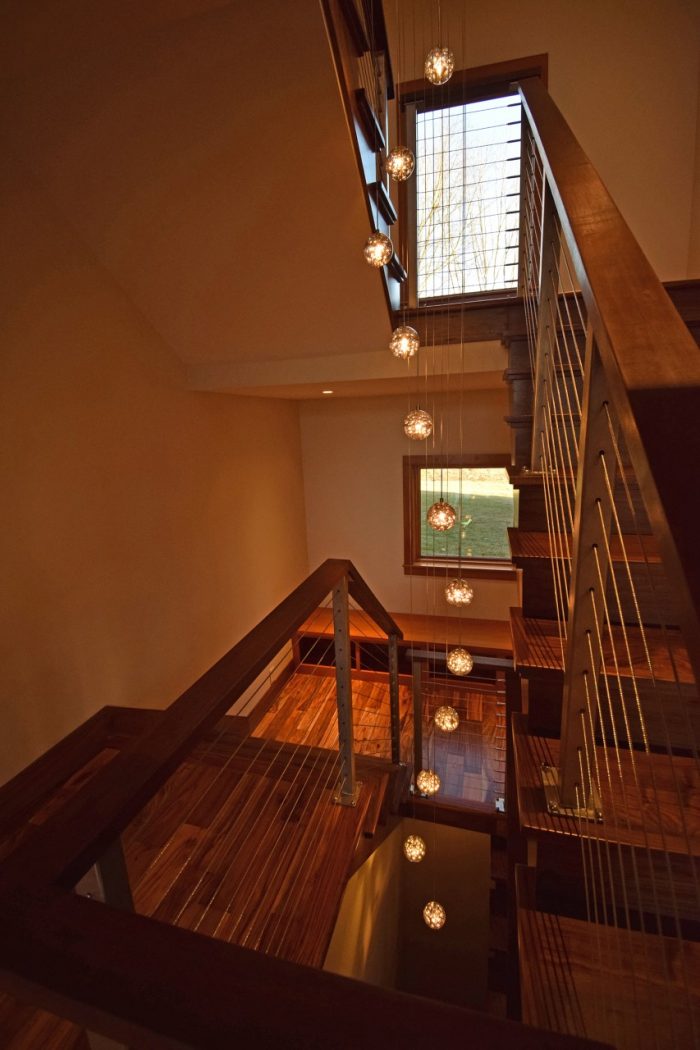 recessed wall lights on landings and cascading chandelier