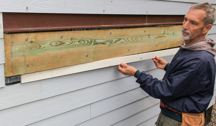 Install the last piece of siding