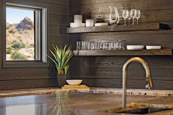 Kitchen with dark composite wood-look cladding. 