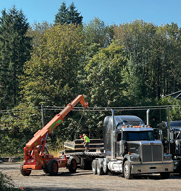 Photo of panels being loaded off of a truck