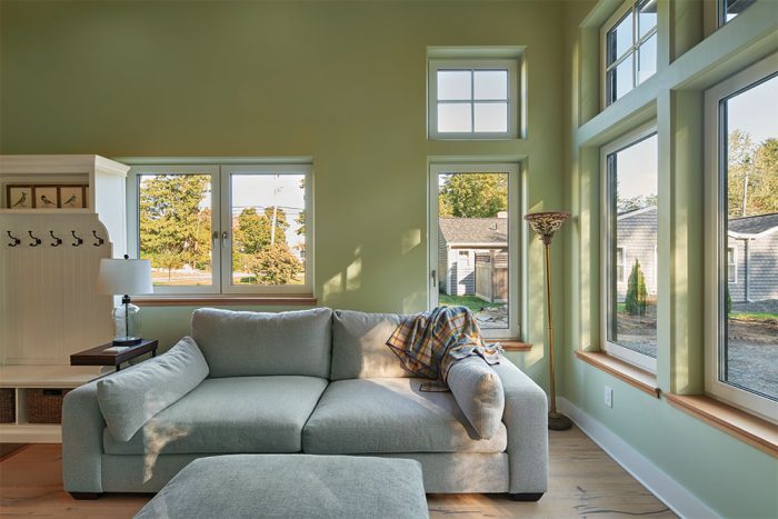 Living room with gray couch and light green walls