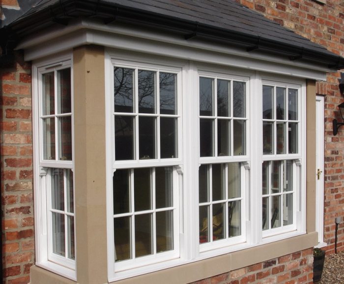 A photograph of four sash windows on a brick building.