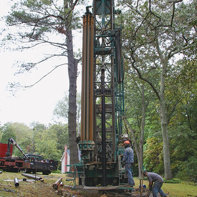 Photo of a well being drilled on the building site.