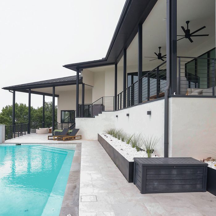 Photo of a pool deck built using noncombustible materials like stucco, steel, and fiber-cement.