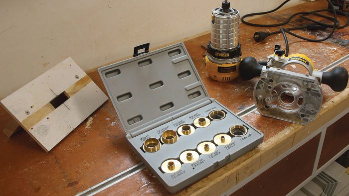 Photo of router and guide bushings on a table.