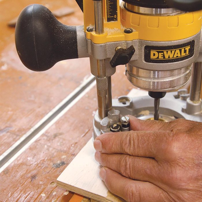 Photo of a hand setting a multiposition turret-style depth stop on a router.