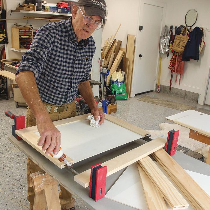 Photo of author, Tim, glueing a pair of tenons into one of the stiles.