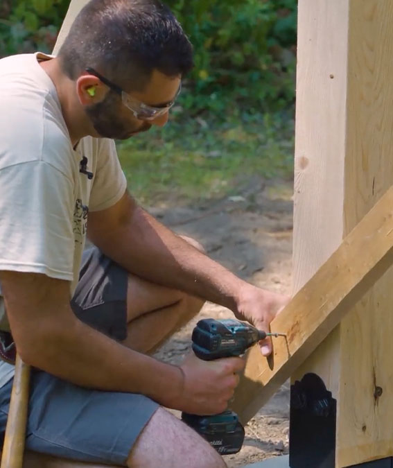 Photo of Jeremy Kassel bracing a pergola post with a 2x4.