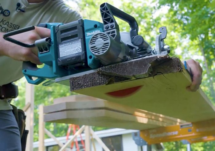 Photo of Jeremy Kassel cutting hemlock boards so they can be used as pergola beams.