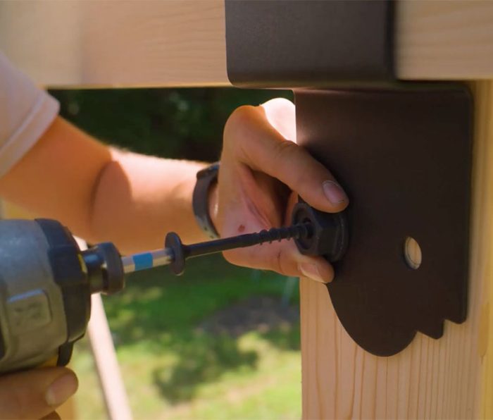 Photo of Jeremy Kassel drilling Simpson Strong-Tie braces into place.