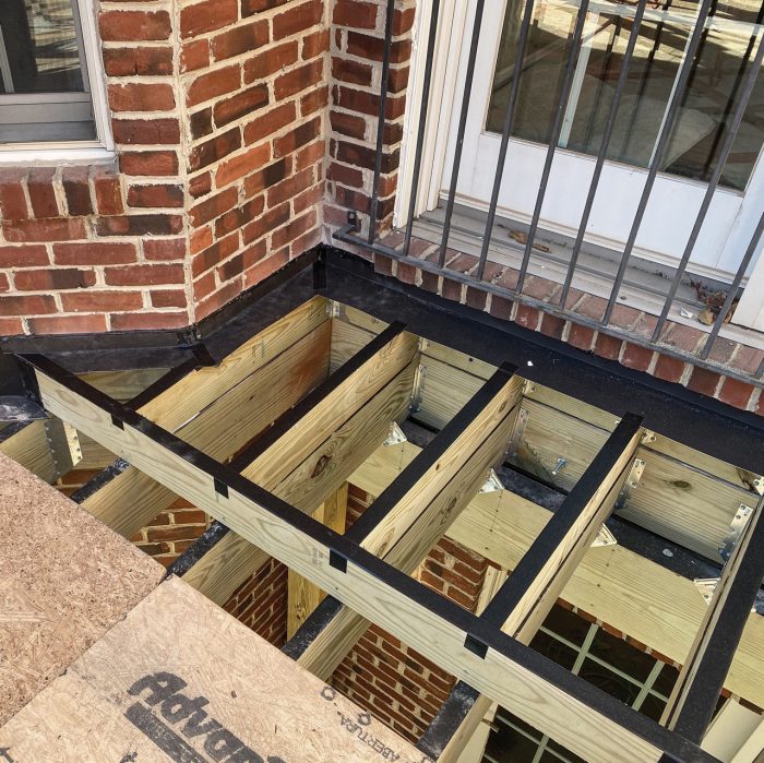 Photo of tap over the tops of deck joists on a deck built with ground-contact pressure-treated lumber.