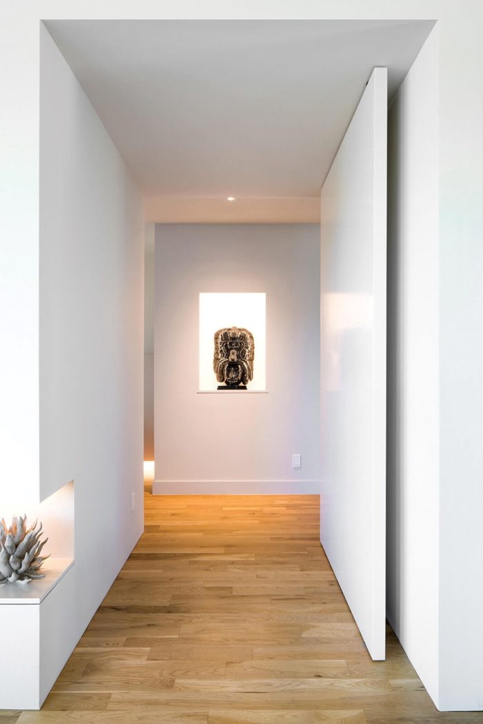 Photo of a hallway lit by recessed downlights.